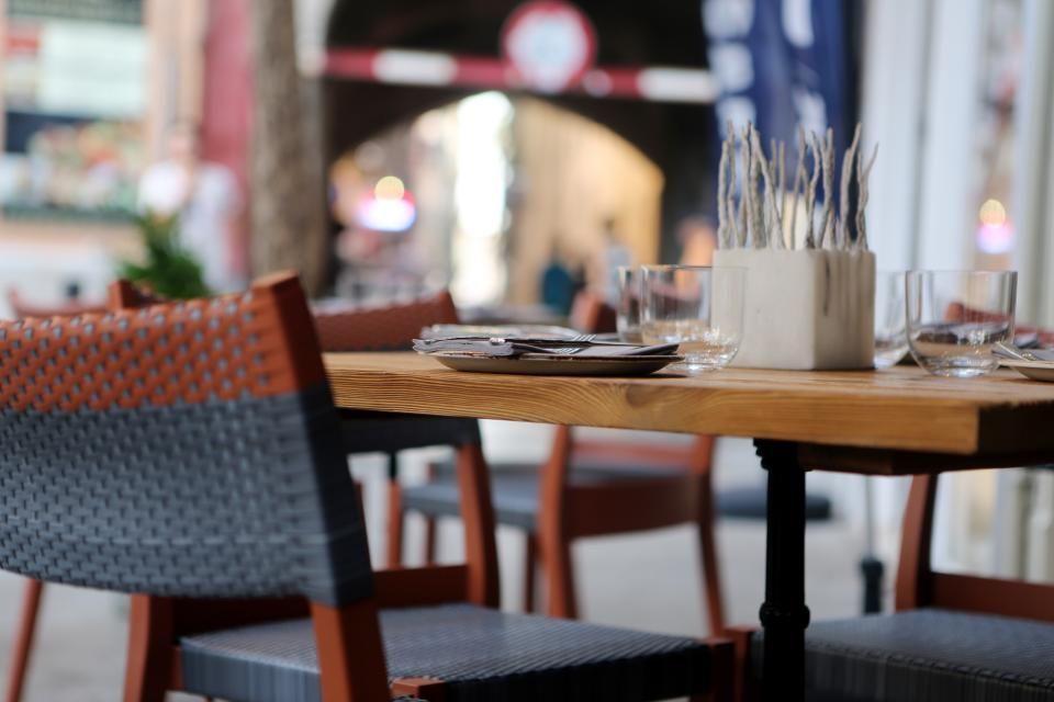 Tables and woven chairs by the street windows